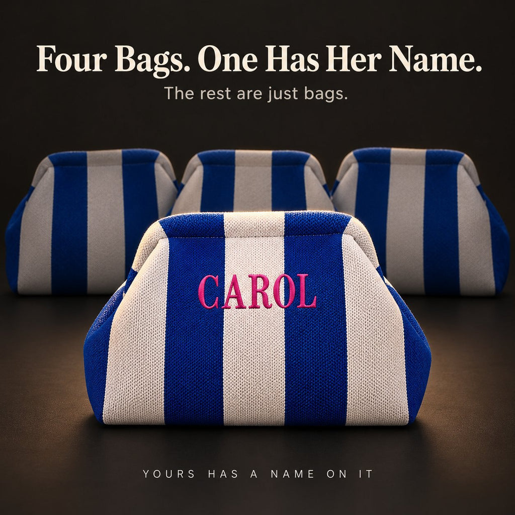 Four cobalt and white mahjong tile bags; only the front one is embroidered "Carol" in hot pink