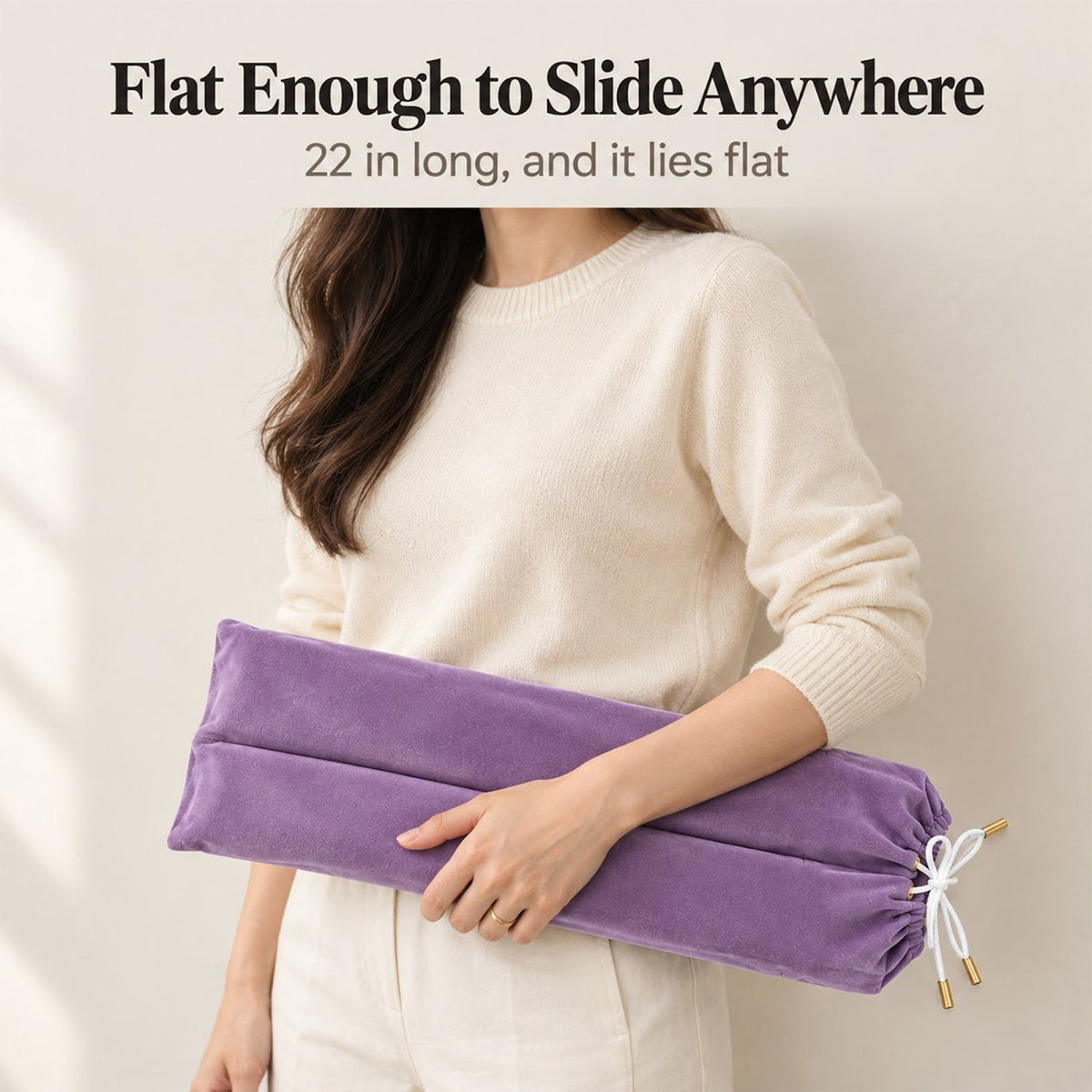 Woman in a cream sweater carrying a lavender velvet mahjong rack bag under her arm