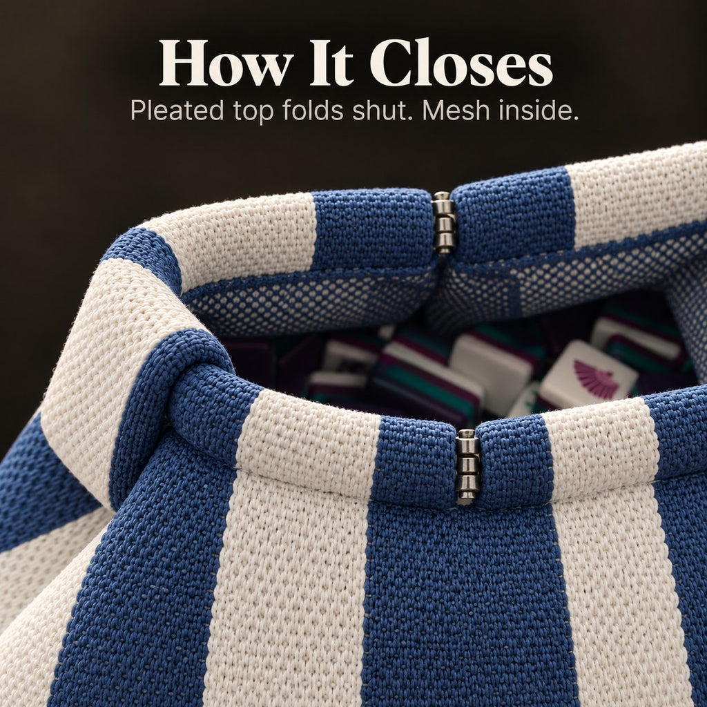 Top of an open blue and white mahjong tile bag with metal hinges, mesh lining and tiles inside