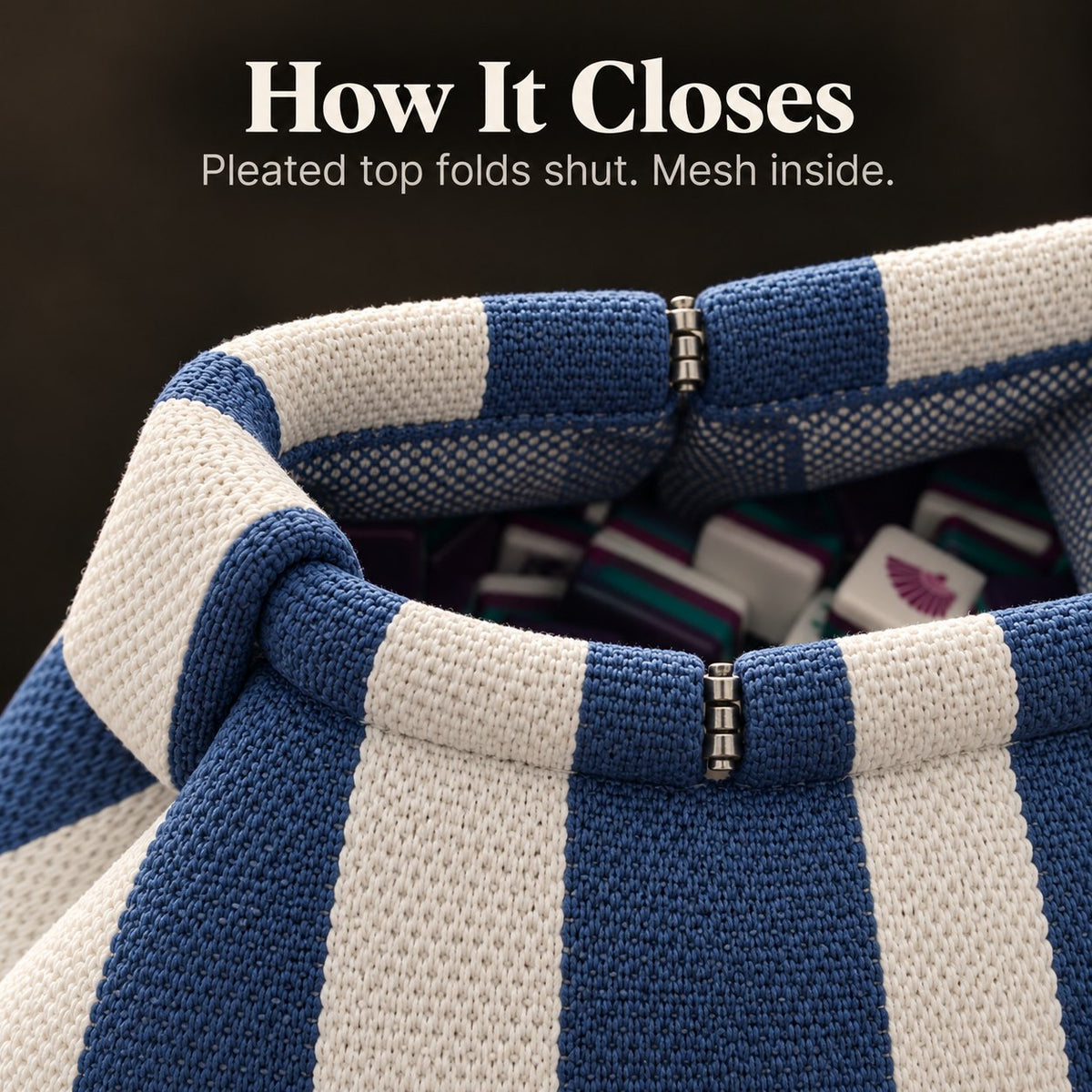 Top of an open blue and white mahjong tile bag with metal hinges, mesh lining and tiles inside