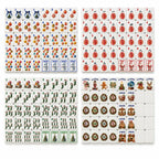 Classic Christmas mahjong set laid out: ornament Dots, gift-box Craks, stocking Bams, flowers, wreath winds, jokers, blanks