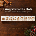 Gingerbread cookie Dots 1 to 9 with blue corner numbers on a wood table with cinnamon and cookie crumbs