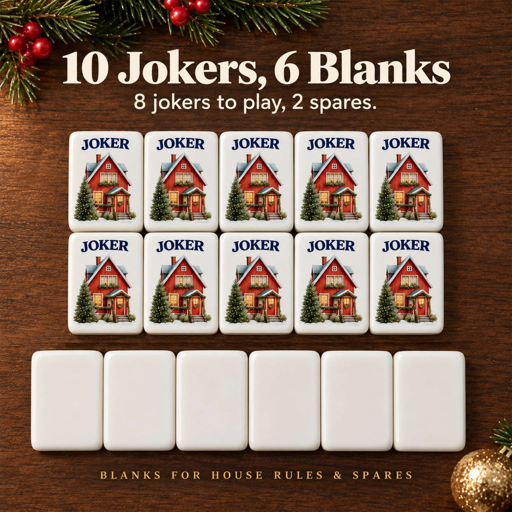 Ten red cottage Joker tiles in two rows above six plain blank tiles on a wood table with pine and berries
