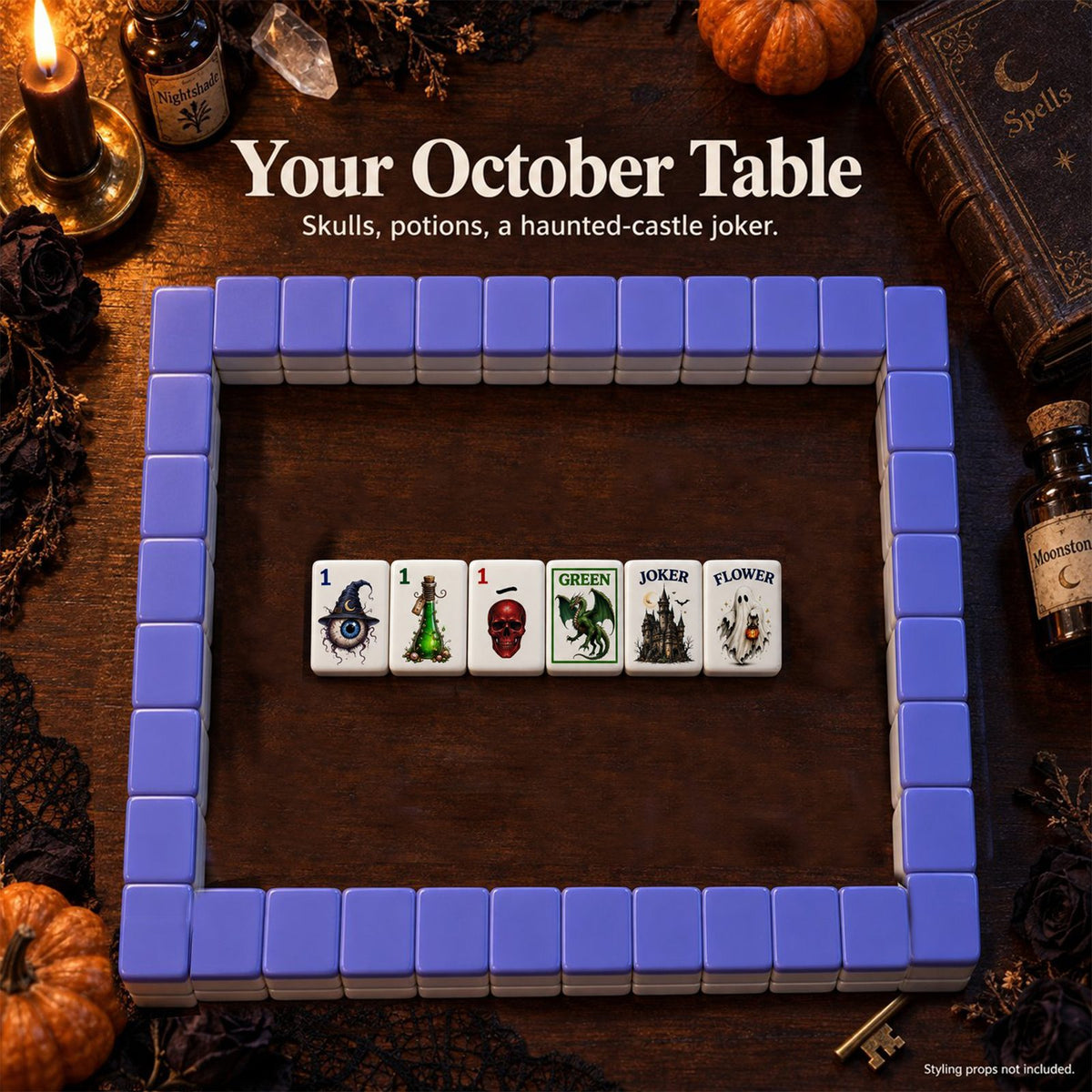 Gothic Halloween mahjong tiles inside a purple-backed tile wall on a dark table with pumpkins, candles and spell book props