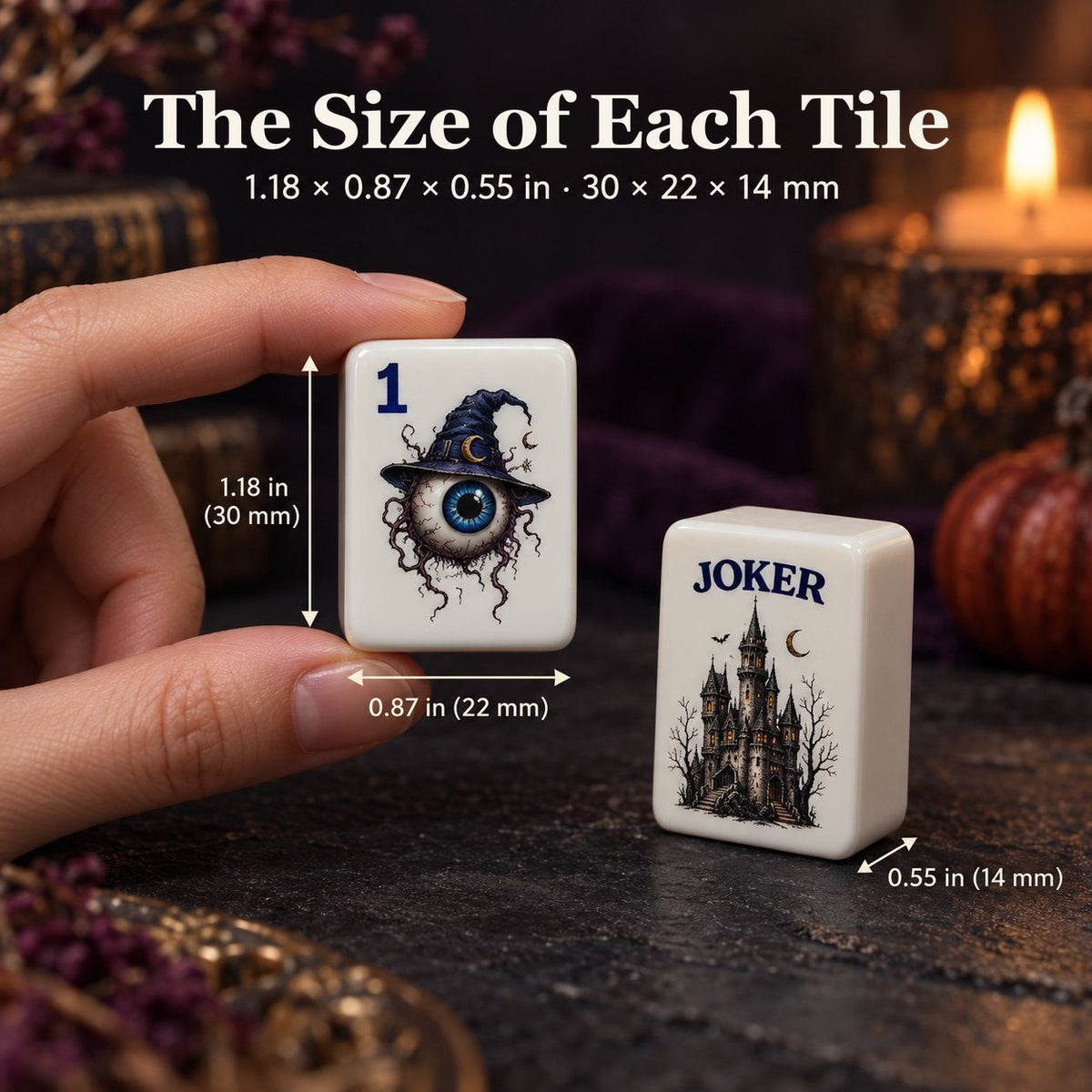 Hand holding a 1 Dot eyeball tile next to a castle Joker tile, sized 1.18 x 0.87 x 0.55 in (30 x 22 x 14 mm)