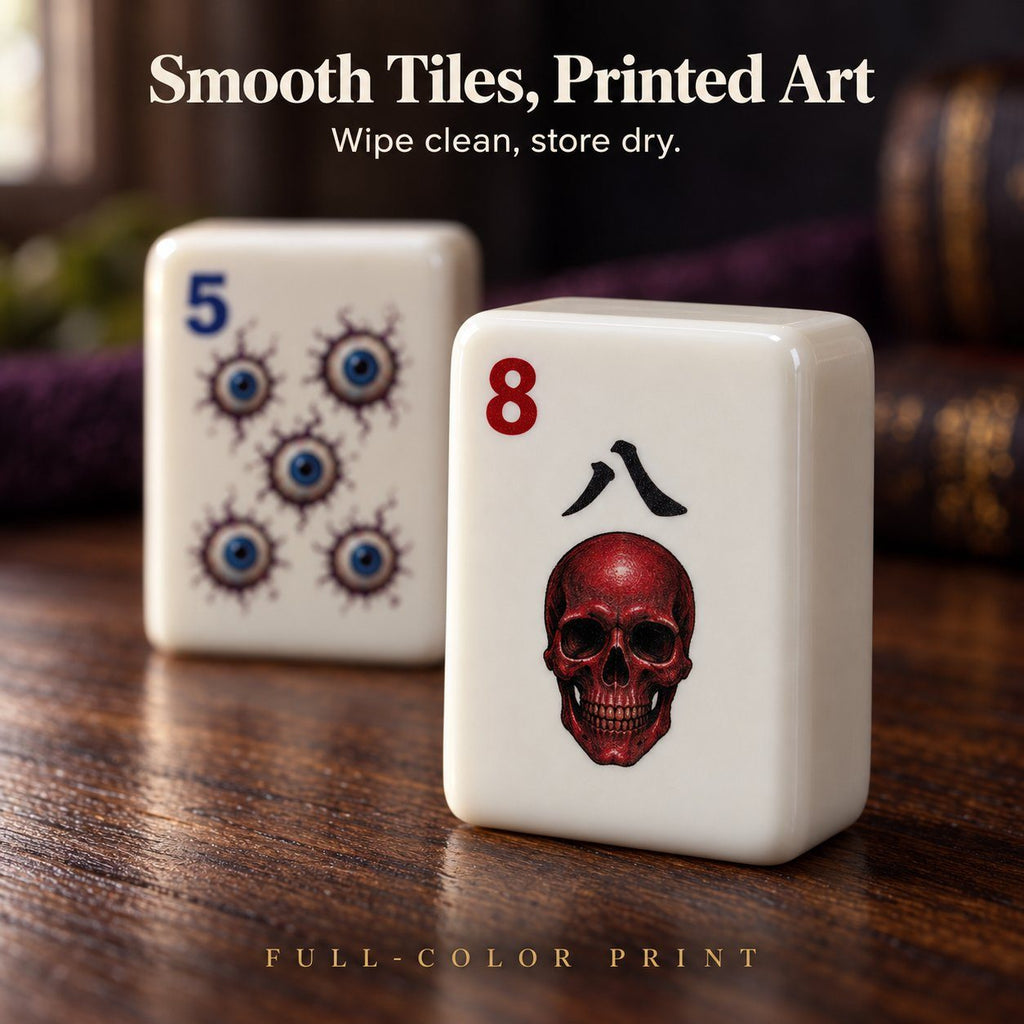 Close-up of a 5 Dot eyeball tile and an 8 Crak red skull tile with full-color printed art on a wood table