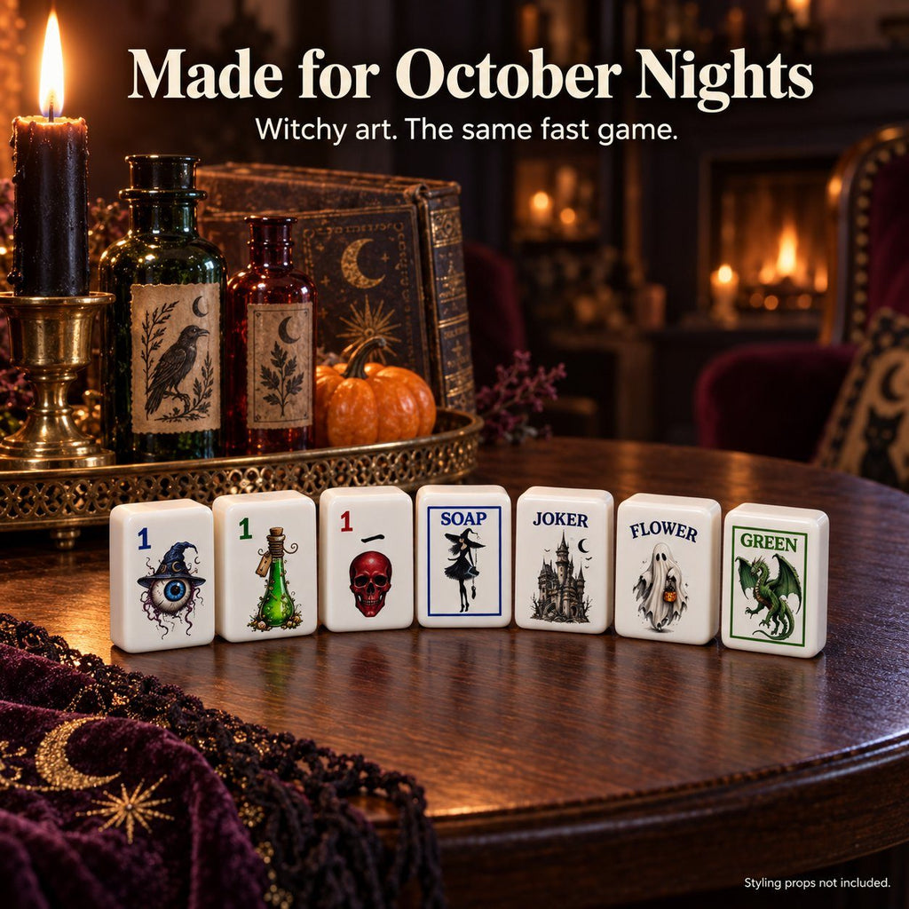 Gothic mahjong tiles 1 Dot, 1 Bam, 1 Crak, Soap, Joker, Flower and Green lined up on a candlelit table