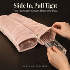 Hands sliding a clear rack into a blush pink velvet mahjong rack bag, captioned "Racks not included"