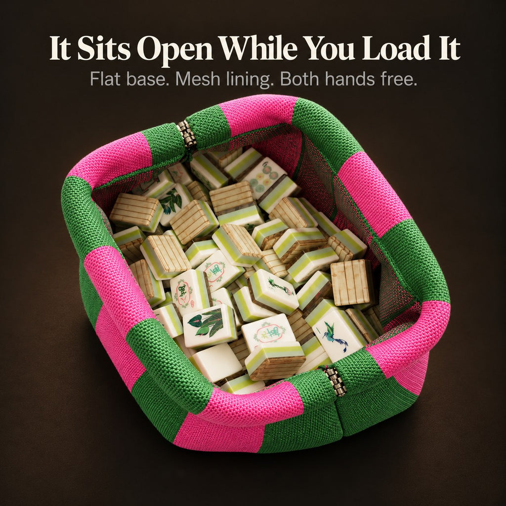 Open green and hot pink mahjong tile bag seen from above, filled with tiles and lined with mesh